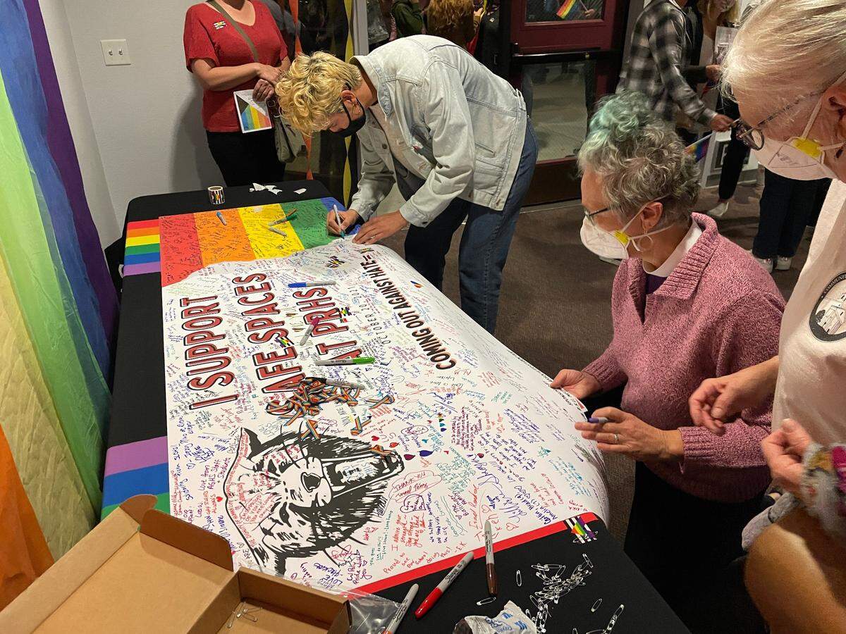 Community members sign a poster showing support for LGBTQ students at Paso Robles High School during a “Coming Out Against Hate” forum event on Oct. 20.