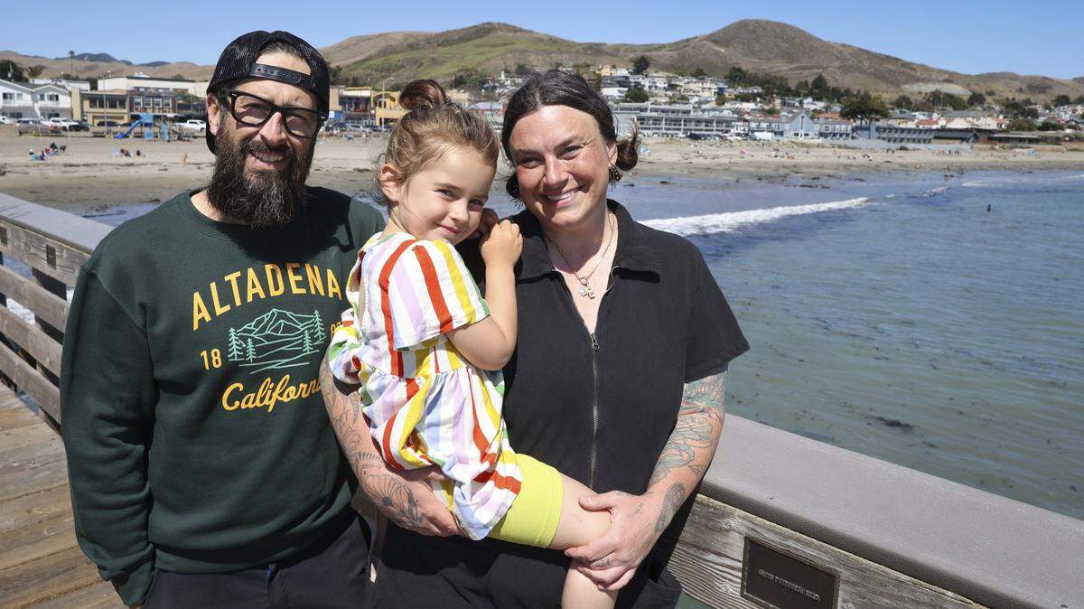 David McAbee daughter Presley,4, and wife Catlin have been living in Cayucos since the Altadena fire destroyed their home. They seen here at the Cayucos Pier July 24, 2025.