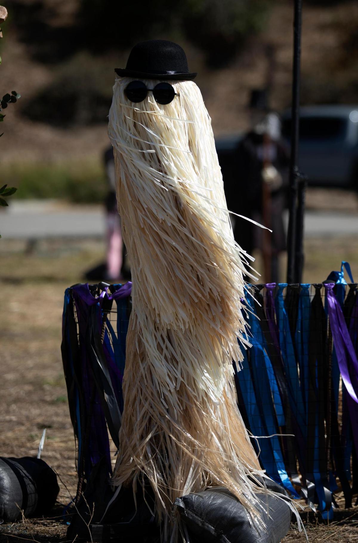 Cousin It appears as part of a scarecrow display paying homage to Netflix show “Wednesday” on display in a dirt lot next to the Shell Station on Main Street in Cambria as part of the Cambria Scarecrow Festival in October 2023.