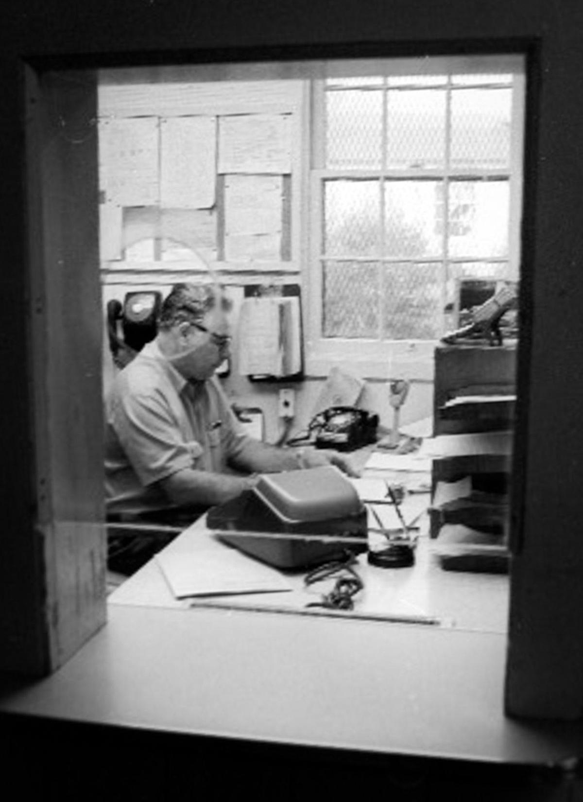 Correctional officer Larry R. O’Connell sits at a desk in the control center where hour-to-hour records are kept of the inmates’ whereabouts. California Men’s Colony West facility tour on Dec. 2, 1970.