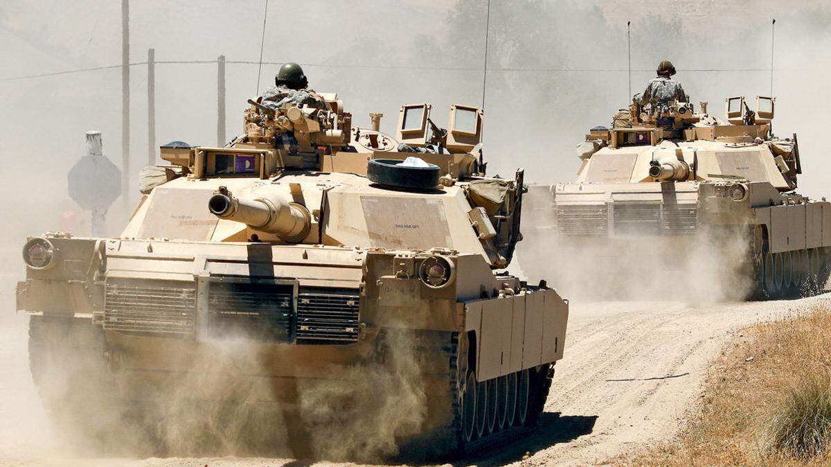 A convoy of M1 Abrams tanks crosses Camp Roberts with guns pointed to the rear during training exercises in June 2015.