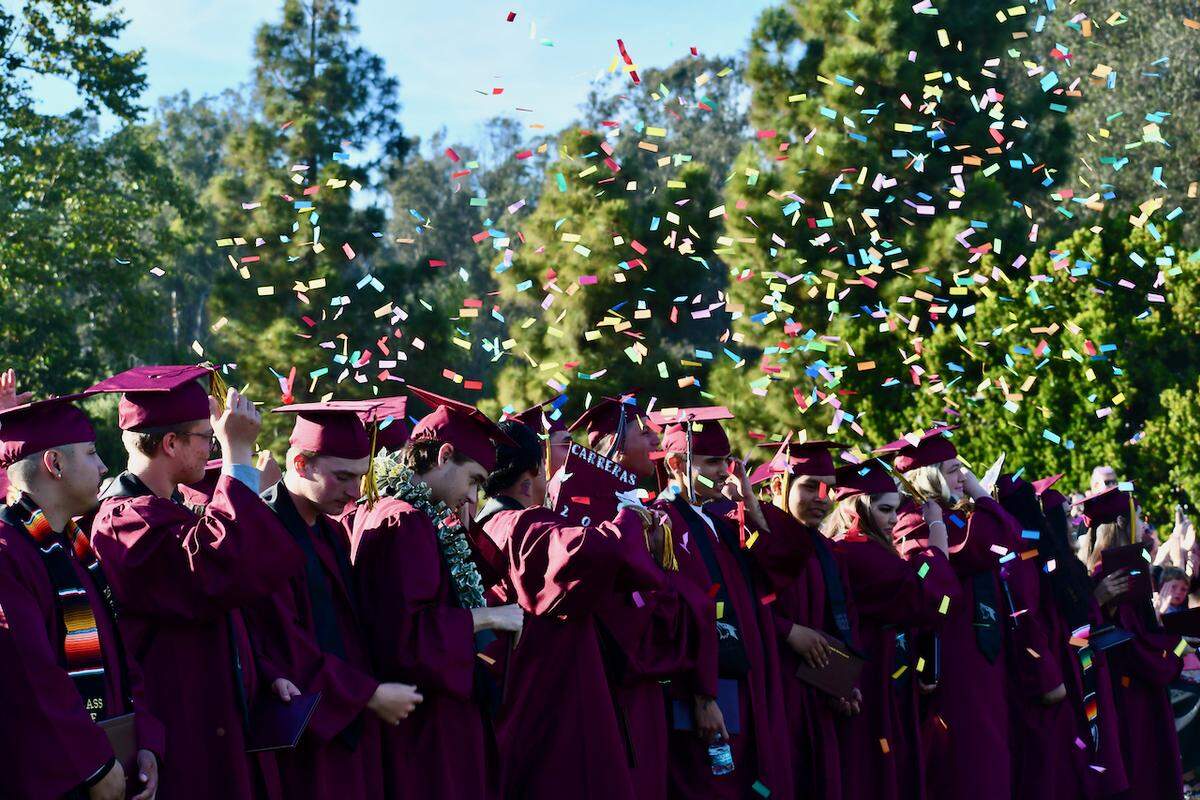 Confetti falls on grads at Lopez Continuation High School’s graduation ceremony.