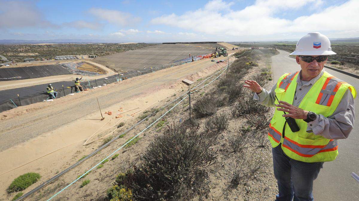 Chevron Environmental Management Co. spokesperson Jeff Moore stands next to the Soil Management Area at the Guadalupe-Nipomo Dunes on Oct. 1, 2025. It’s designed to store contaminated sand from the former Unocal oil field, which is in the midst of a 30-year cleanup.