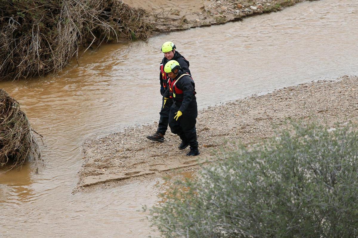 Searchers check through floodwaters for any sign of 5-year-old Kyle Doan on Wednesday, Jan. 11, 2023, two days after he disappeared in swollen San Marcos Creek near San Miguel.