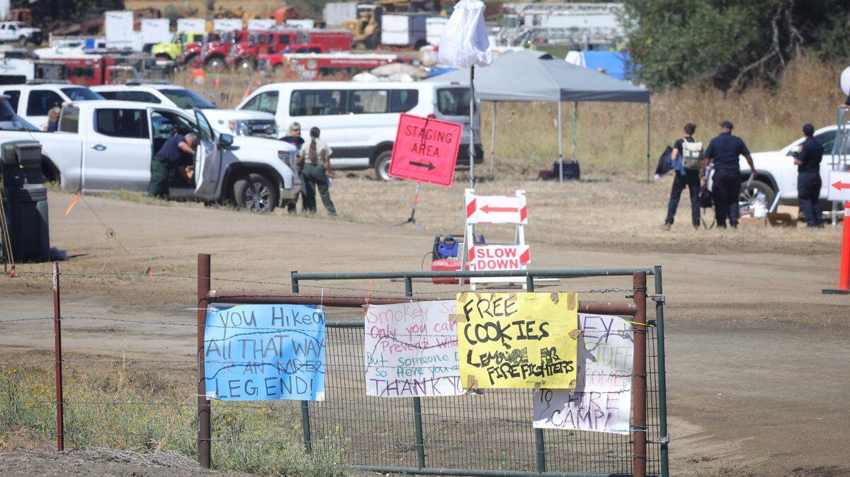 Signs supporting firefighters line the gate to the fire camp at Santa Margarita Ranch on Aug. 13, 2025. The Gifford Fire is in its 13th day and has grown to one of the largest in San Luis Obispo County history.