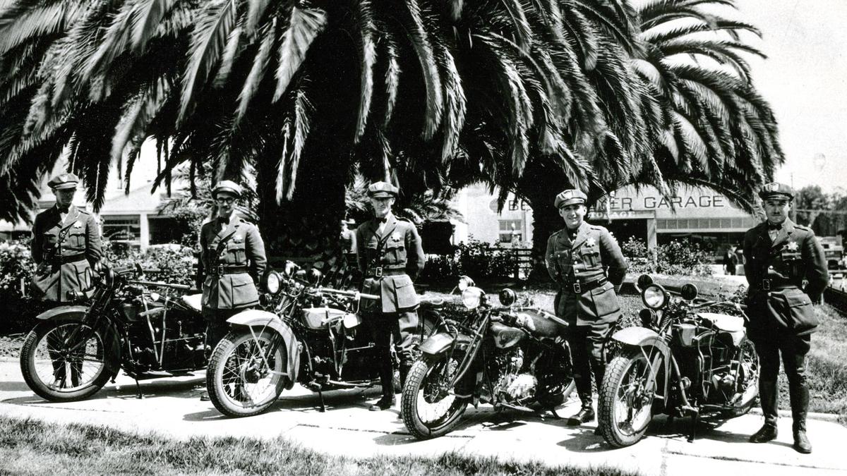 Highway Patrol circa 1929 outside the San Luis Obispo county courthouse at the corner of Monterey and Osos Streets. The officers are from the left: S.J. Lusardi, Roy Alonzo Porter, Chet Fulton, George Donnelly and Capt. Cleon Kyte.The Berkemeyer Garage is in the background, now Mo’s Smokehouse. The California Highway Patrol was founded in August 1929 so this is more likely the date for the photo rather than the original caption which placed the date in 1927.