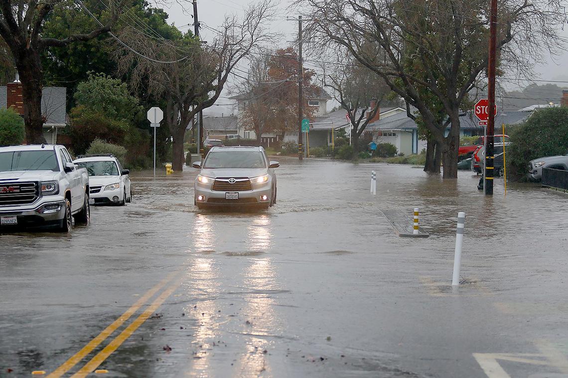 Oceanaire Drive west of Madonna Road is flooded by nearby Laguna Lake is San Luis Obispo. The road was closed at the intersection on Jan. 9, 2023.