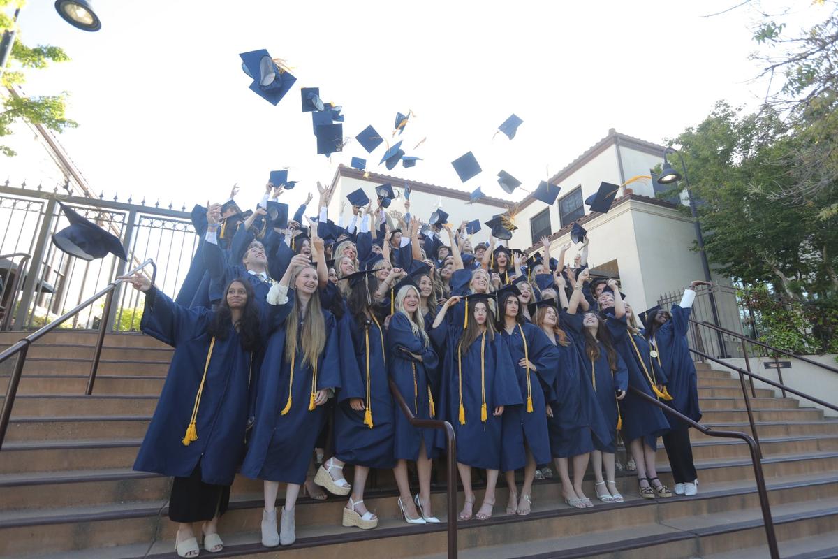 In a longstanding tradition, students gather on the steps of the school to toss their mortarboards for a photo before the ceremony begins. Mission College Prep awarded diplomas to 69 graduates May 31, 2024.