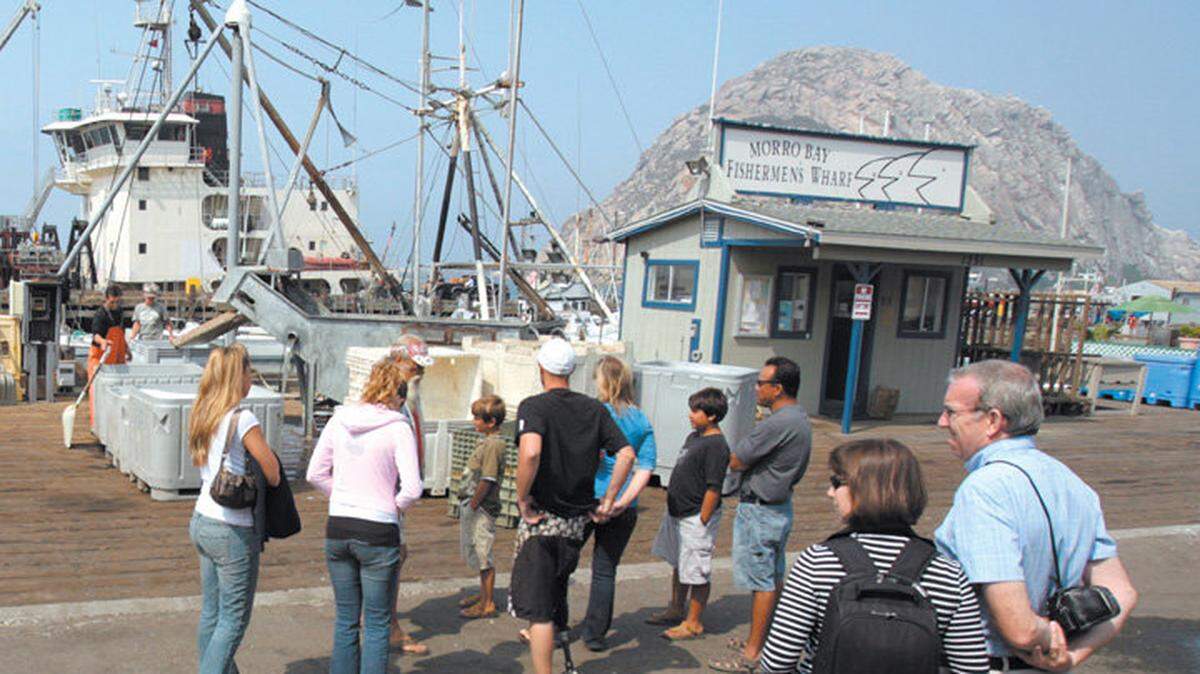 Tourists stop to watch fish being unloaded at the Morro Bay Fishermen's Wharf.