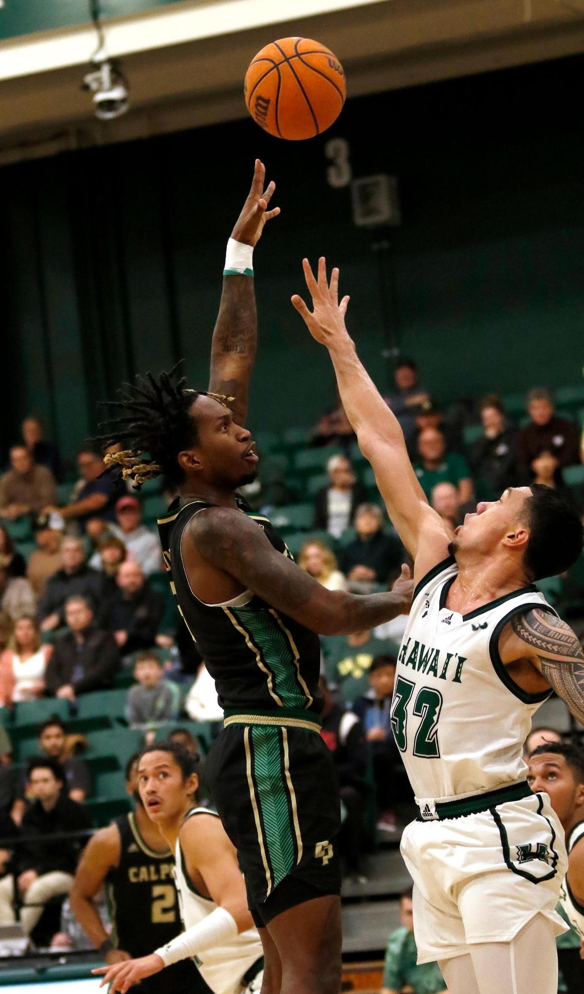 Cal Poly’s Chance Hunter (31) goes for a basket over Hawaii’s Samuta Avea (32). Cal Poly loses to Hawaii 56-69 at the Cal Poly State University ’s Mott Athletic Center, San Luis Obispo, CA, Saturday, Feb 4, 2023.
