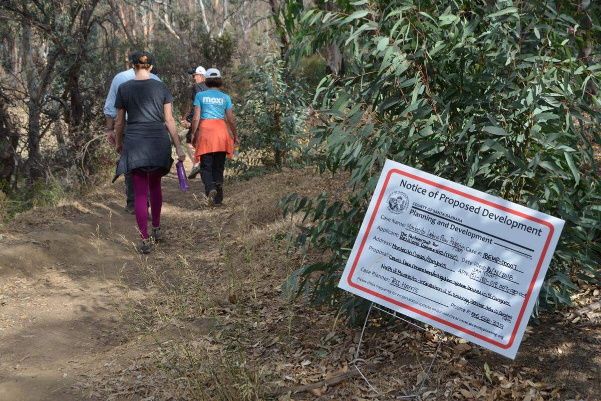A sign along the San Ysidro Trail indicates an application for or installing metal debris nets to help prevent debris flows.
