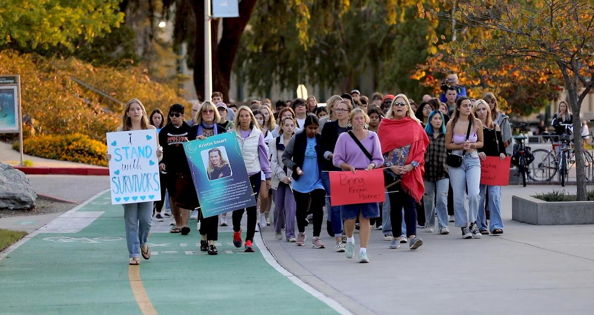 Student organizers of the vigil, Layla Burack, front and Kallie Kidder, right, lead the group of marchers to Muir Hall. A vigil organized by Cal Poly Safer, a group that focuses on education and prevention of sexual and gender-based violence. for Kristin Smart was held on the Cal Poly Campus Friday evening, Oct. 21, 2022. (Laura Dickinson, The Tribune, San Luis Obispo).
