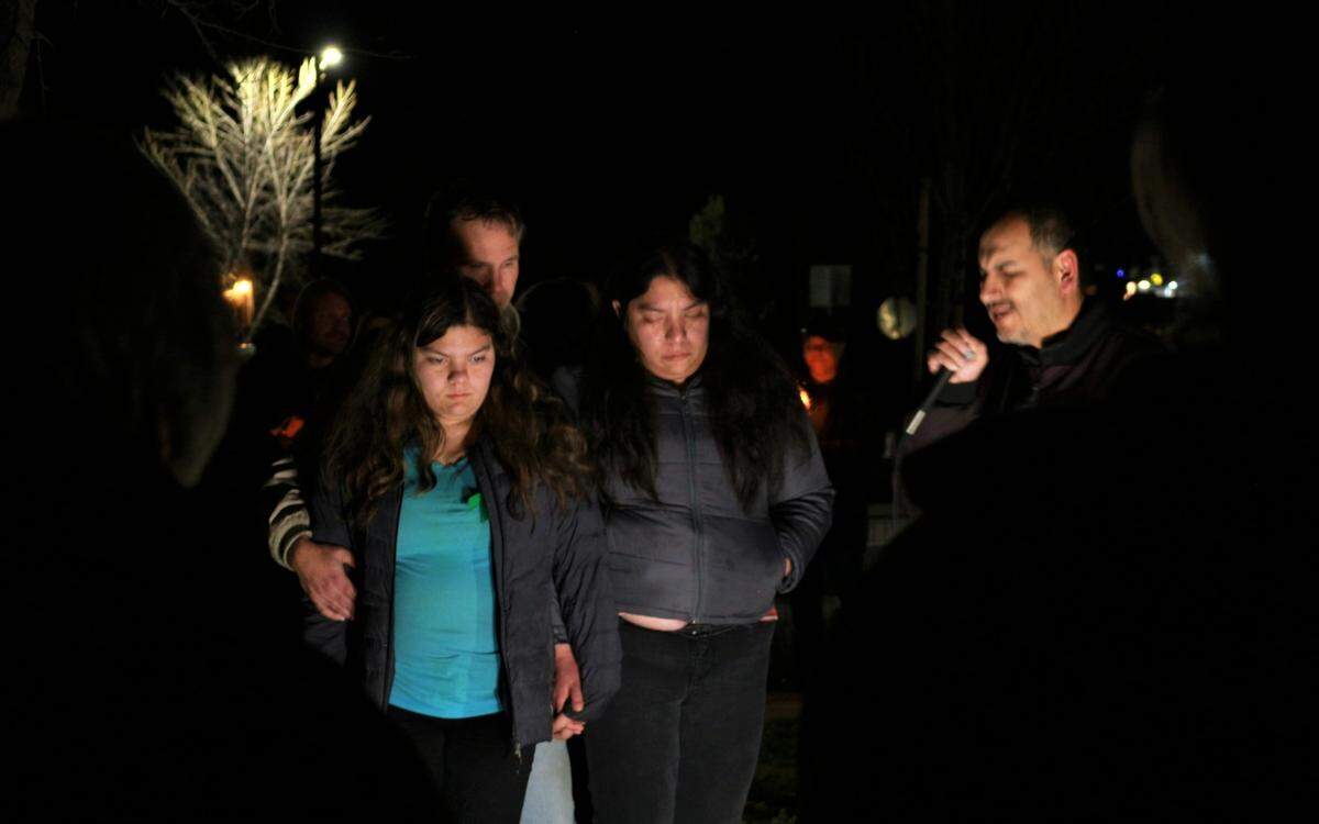 From left, Melanie, Brian and Lindsy Doan stand next to Pastor Leo Martinez as he prays for Kyle Doan during a vigil for the missing boy from San Miguel on Jan. 12, 2023. Kyle was swept away in floodwaters during a storm that hit San Luis Obispo County on Jan. 9.