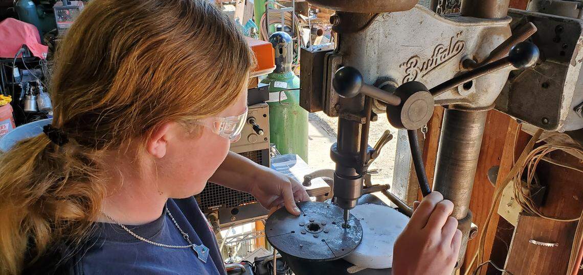 Templeton High student Mackay Langley machines a part for her dozer-rebuild project. Her engineering class project will be part of the Maker Faire May 19.
