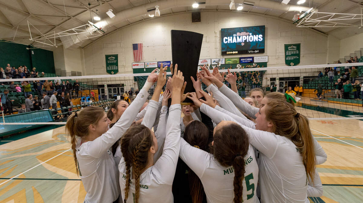 The Cal Poly volleyball team raises its second consecutive Big West Conference championship trophy.