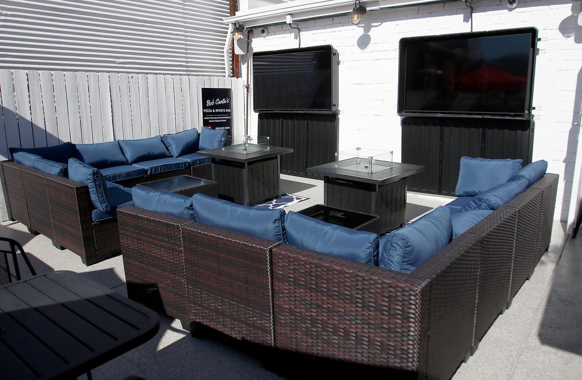The back patio area Bob Cantu’s Pizza and Sports Bar in San Luis Obispo features two large screen TVs and a bar.