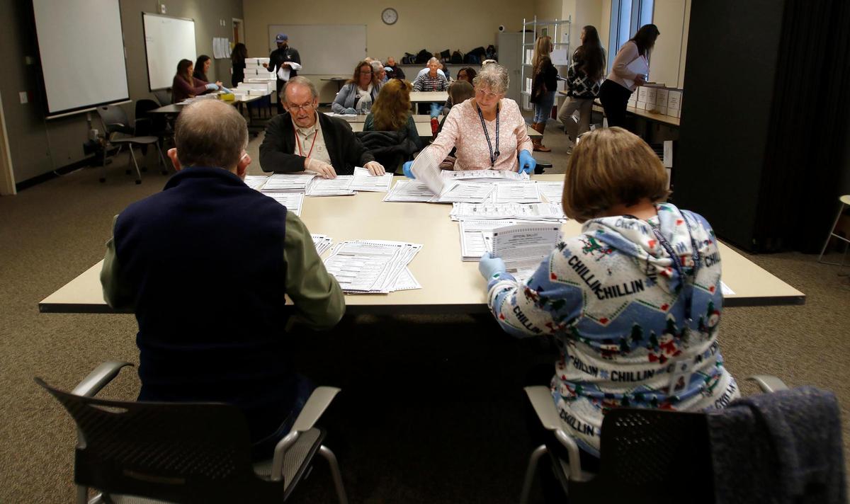 Volunteers sort ballots in an auxiliary room at the Katcho Achadjian Government Center on Tuesday, Dec. 20, 2022 as the recount of the District 2 supervisor race proceeded.