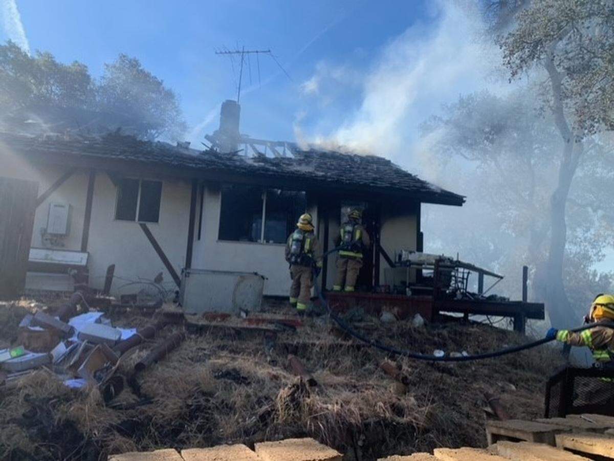 Heavy flames set off ammunition and torched more than half of an Atascadero residence Friday afternoon, the city said, with a half acre of vegetation also burning toward nearby structures.