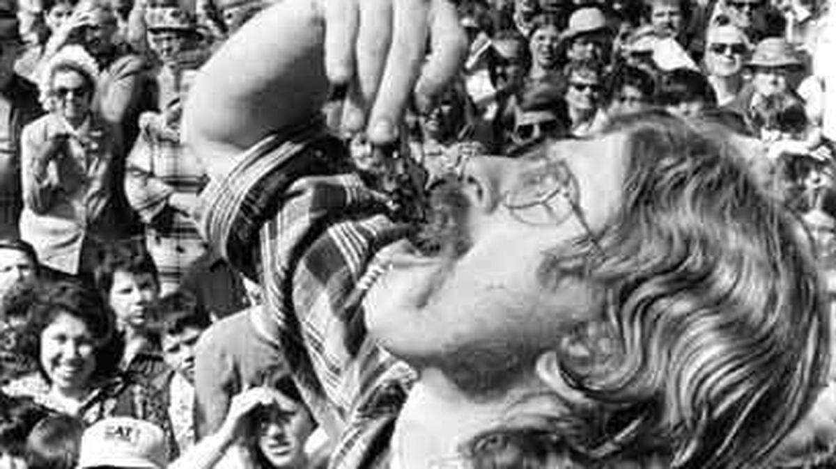 Steve Parich, who took deep breaths before each bite, drops an oyster down the hatch. At the Morro Bay Oyster Festival, oyster shucking contest in May 1974. ©The Tribune