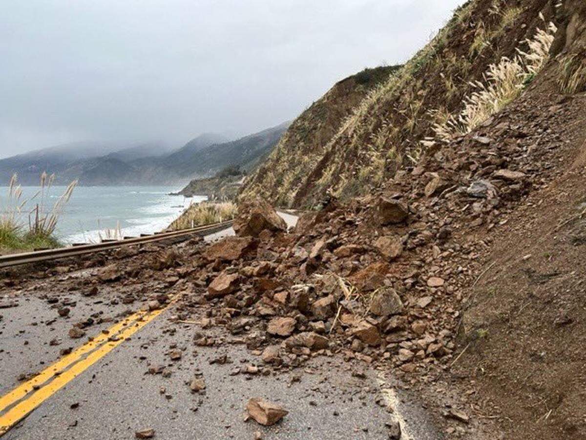 Caltrans maintenance workers removed rocks and debris along Highway 1 south of the Paul’s Slide area near Nacimiento-Fergusson Road in Monterey County on Thursday, Dec. 29, 2022.