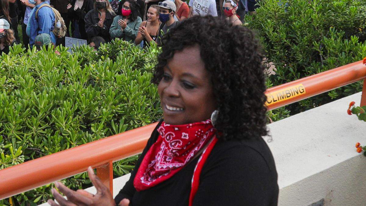 Cheryl Vines with the local NAACP dances with the crowd at the courthouse in San Luis Obispo during a #WeAreDoneDying rally in July 2020.