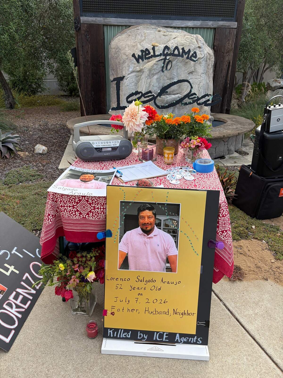 Estero Bay Indivisible organized a vigil at the corner of Los Osos Valley Road and South Bay Boulevard on July 13, 2026, to protest the killing of Lorenzo Salgado Araujo in Houston, Texas, on July 7, 2026.