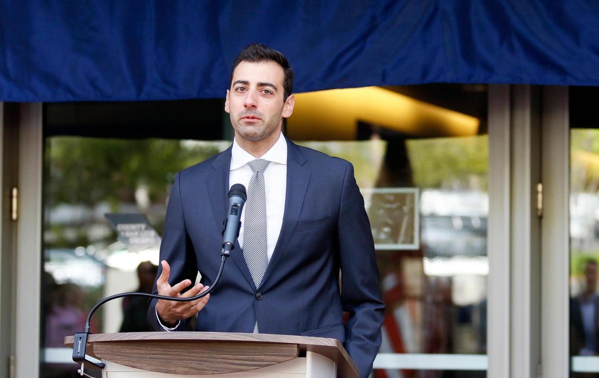 The new Katcho Achadjian Government Center sign was unveiled in a ceremony Friday, Oct. 20, 2023, in front of the former San Luis Obispo County Government Center. SLO County Supervisor John Peschong emceed the festivities. Achadjian’s wife Araxie, his daughter Nyri and son Hratch all spoke before Araxie pulled down a blue cloth revealing the new sign. Here, Achadjian’s son Hratch addresses the crowd at the podium.