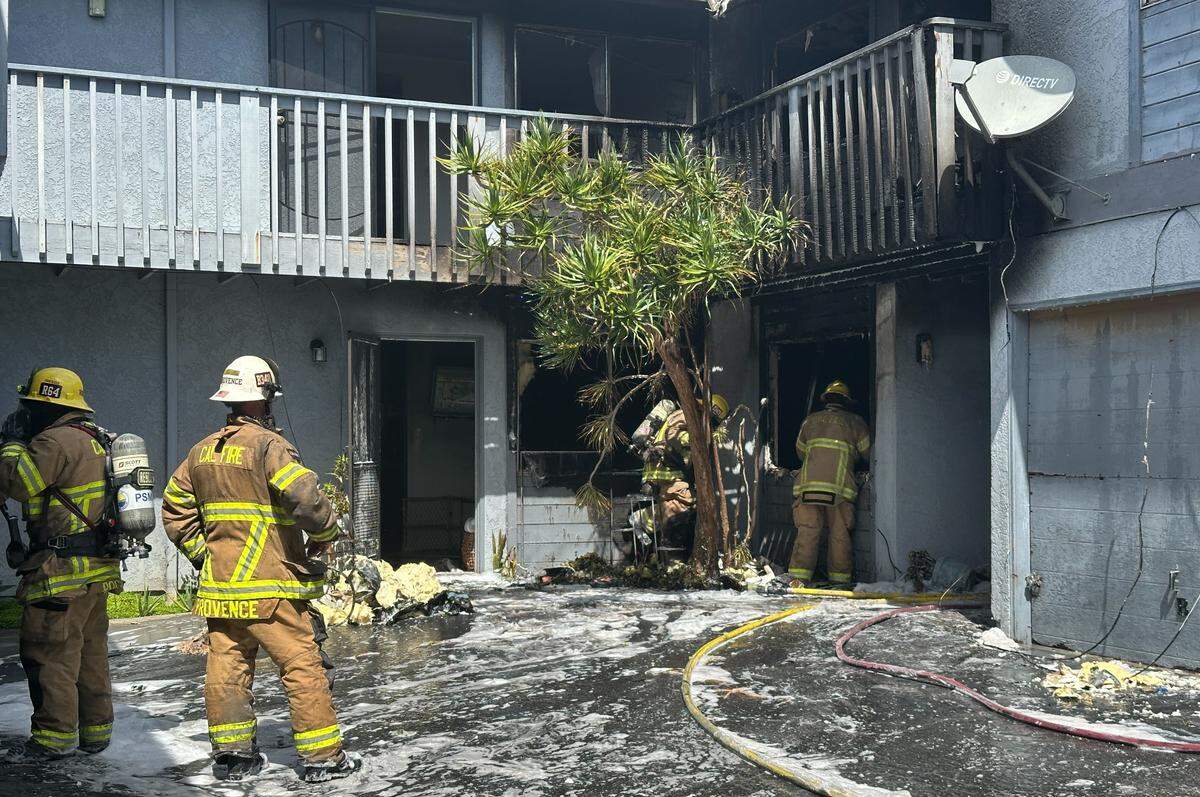 Firefighters assess damage after a fire destroyed four apartments in Grover Beach on Tuesday, July 29, 2025.