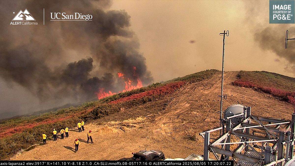 Firefighters watch as flames from the Gifford Fire approach ALERT California’s La Panza 2 camera on Tuesday, Aug. 5, 2025.