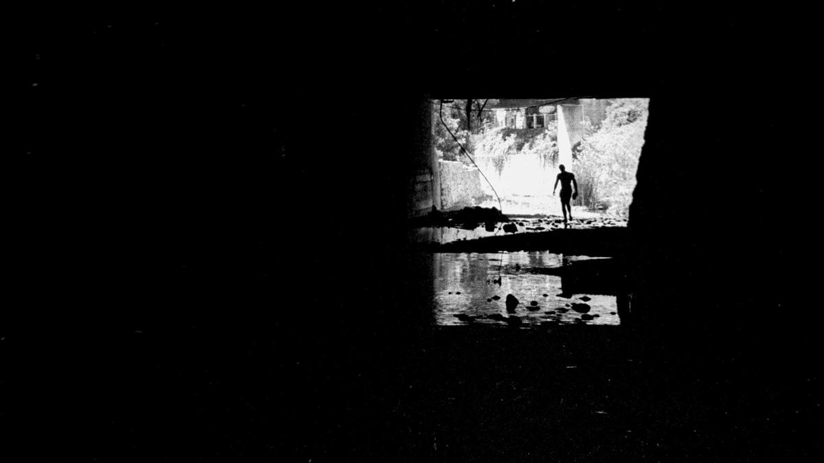 San Luis Creek flows under the city for a little over two blocks below Higuera Street. Most of the route is unlit darkness. This view is from Sept. 5, 1975.