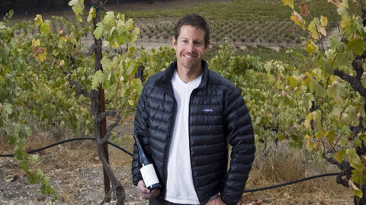 Justin Smith, shown in 2009 with a bottle of his Saxum Vineyards wine, which received a perfect score of 100 points from wine critic Robert Parker of Wine Enthusiast.