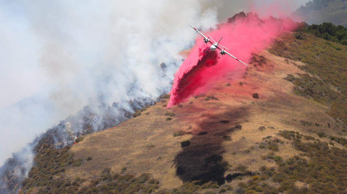 An air tanker drops near Highway 101 on the Cuesta Grade.