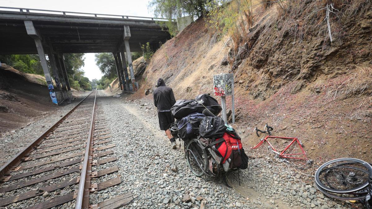 Curtis, 53, hauls his belongings away after the city of San Luis Obispo cleared a homeless camp in 2022. The San Luis Obispo County Board of Supervisors voted on Tuesday, Aug. 8, 2023, to spend $3.4 million on software for managing homelessness data.