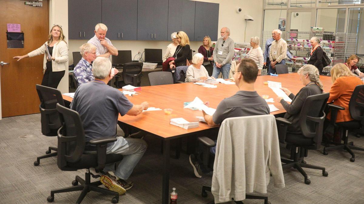 Public Information Specialist Erin Clausen of the San Luis Obispo County Clerk-Recorder’s Office leads observers through vote processing. The observers were Cal Poly retired faculty and staff. At table, ballots are processed at the San Luis Obispo County elections office Nov. 7, 2024.