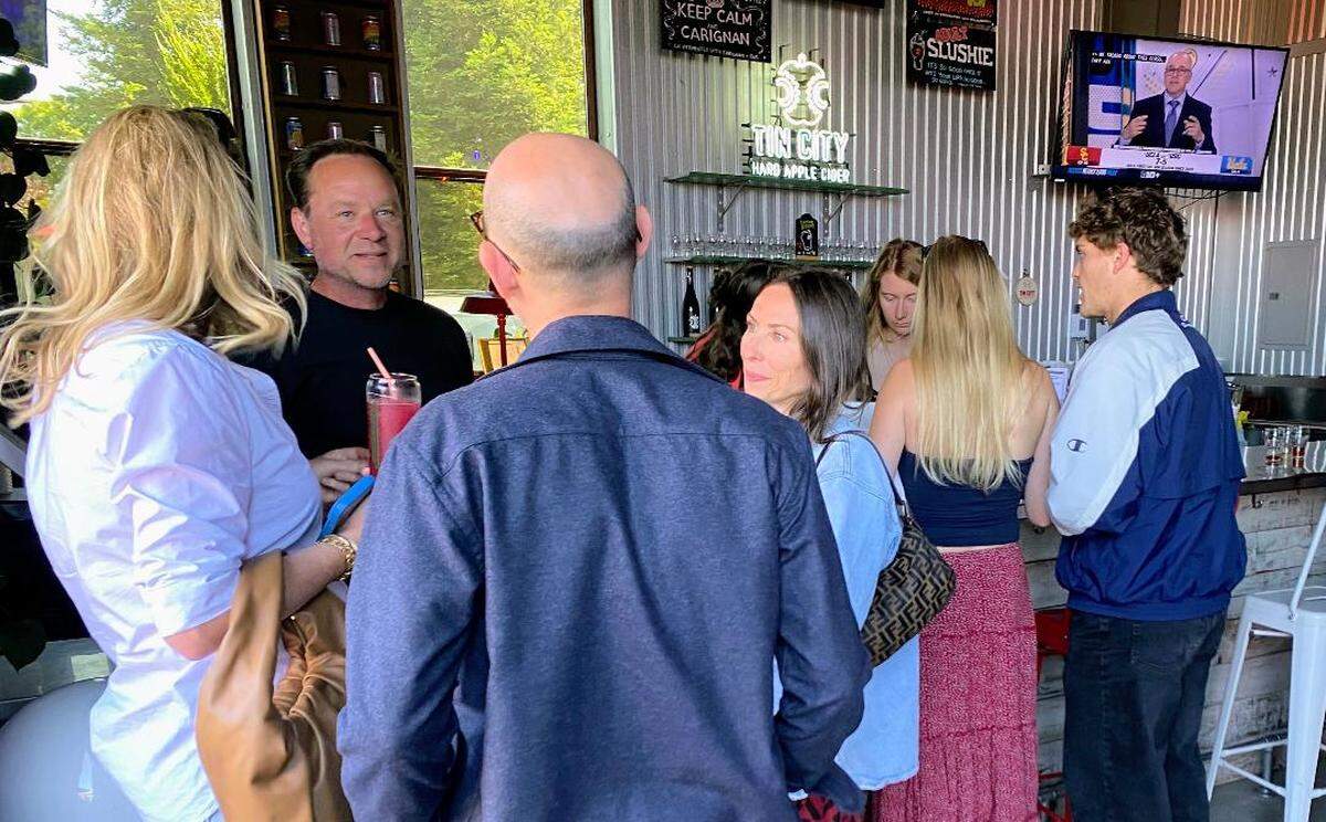 Curt Schalchlin of Tin City Cider Co. speaks with guests inside the Paso Robles tap house on May 23, 2026. The business announced this month that its tap house will close after 10 years in Tin City.