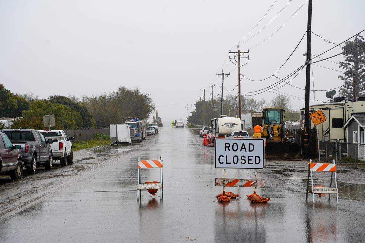 San Luis Obispo County Department of Public Works officials monitor the Arroyo Grande Creek levee’s overflow levels on March 10, 2023. 