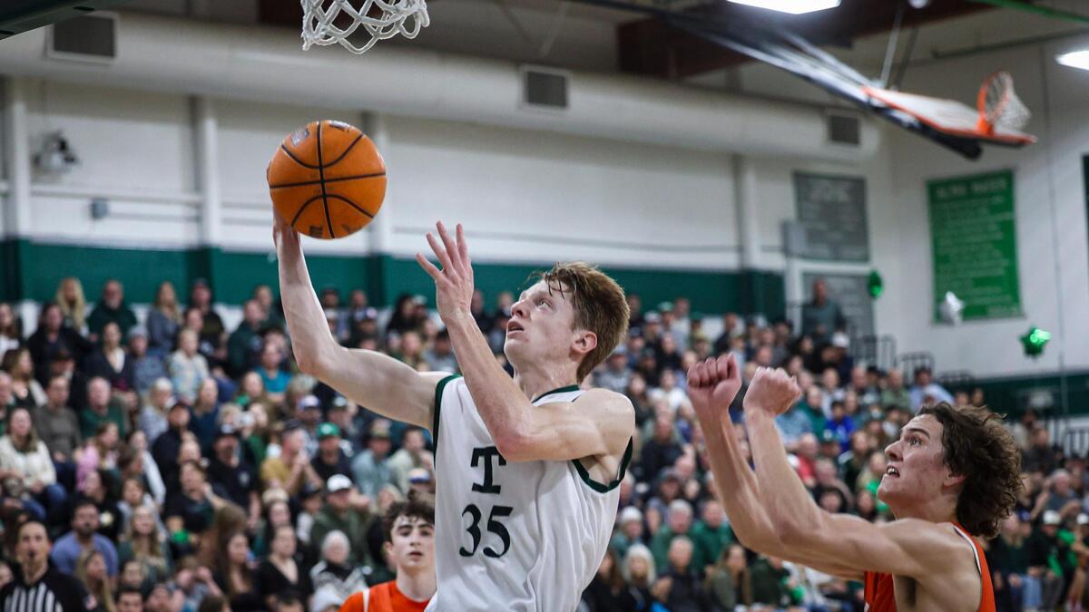 Luke Asplund drives to the basket as Mason Degnan defends. Templeton High School pulled away in the final minutes, beating Atascadero in a boys basketball game on Feb. 6, 2024.