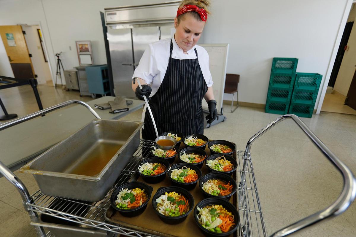 Rebecca Polson, a consultant chef, pours warm broth over ramen and fresh vegetables at Flamson Junior High School in Paso Robles, where students enjoy from-scratch meals made with fresh ingredients from local farms and ranches.