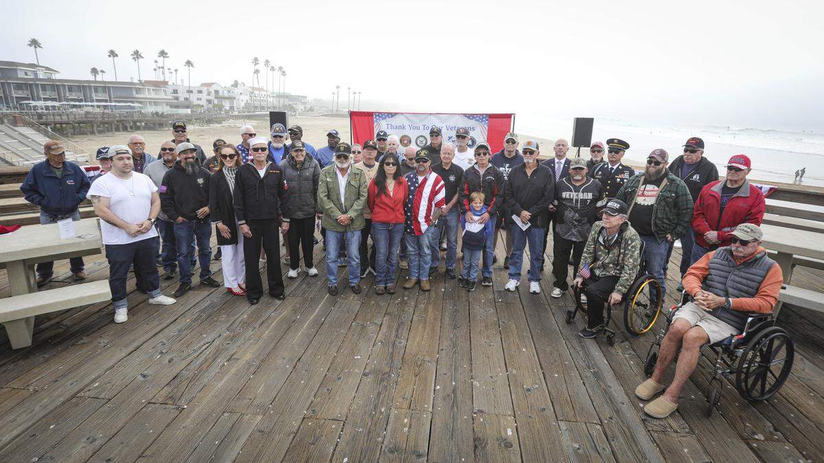Veterans were called to the front at the end of the celebration for a group photo. About 200 people attended a Veterans Day Celebration at the Pismo Beach Pier on Nov. 1, 2025.