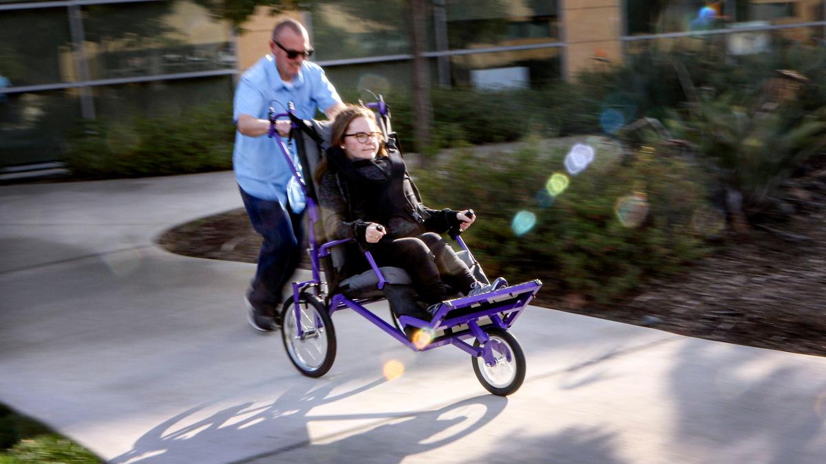 Edward Robinson of Fresno pushes his daughter, Katie, in a jogger made by Cal Poly San Luis Obispo students.