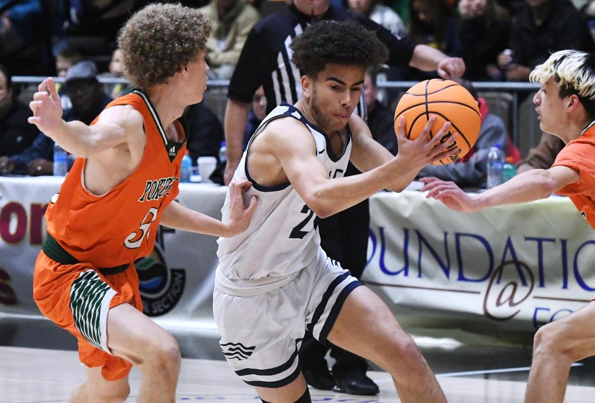 Arroyo Grande’s Adam Silmon, center, with Porterville’s Camden Haynes, left, and Cooper Fish, right, at the CIF Central Section basketball championships Friday, Feb. 24, 2023 in Fresno. Arroyo Grande won 59-30.