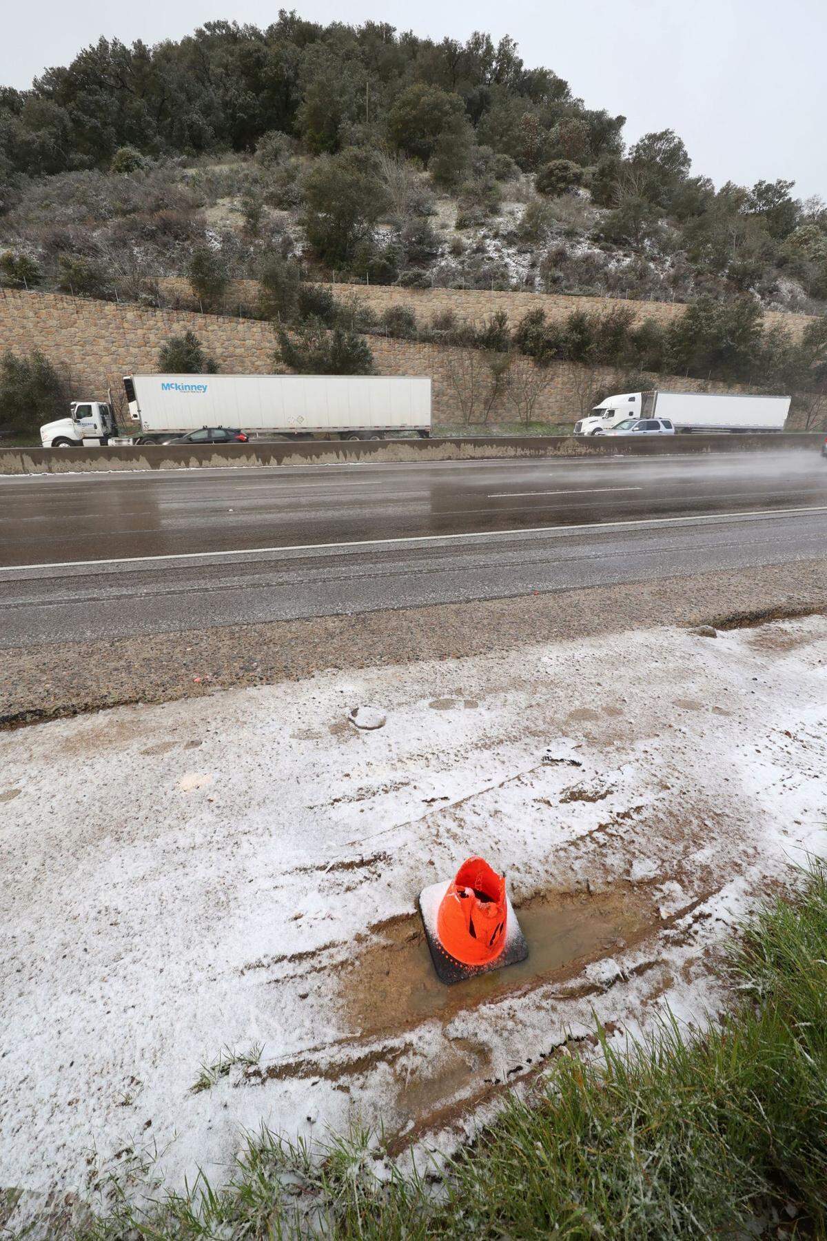Slush coats the side of Highway 101 on the Cuesta Grade on Thursday, Feb. 23, 2023.