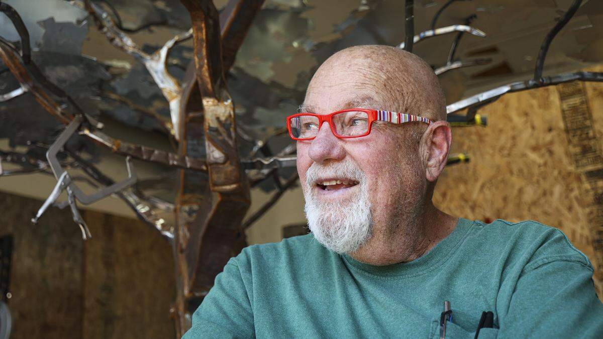 Allen Root is a metal artist who had been working on chronic health issues, seen with a work he was collaborating with David Curry, a large metal tree, on July 10, 2024.