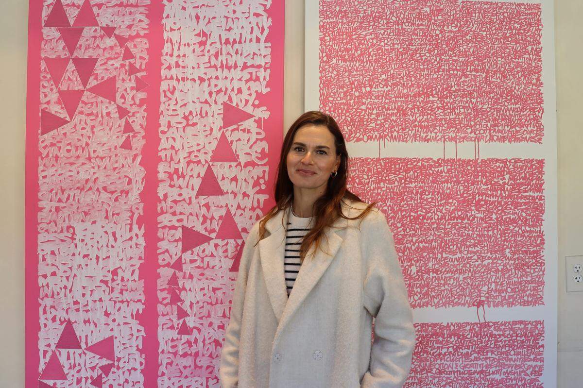 Zoya Dixon, Templeton-based artist, poses with a pair of paintings she created with her brother and creative partner, Sam Lopata. The paintings, titled “ENTROPY” and “CONSTANTS,” explore the power of artificial intelligence to harness human emotion.
