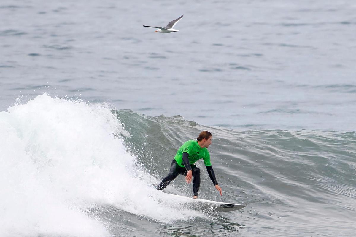 A surfer competes at the SLO CAL Open Qualifying Series at Morro Rock on Saturday, Feb. 26, 2022.