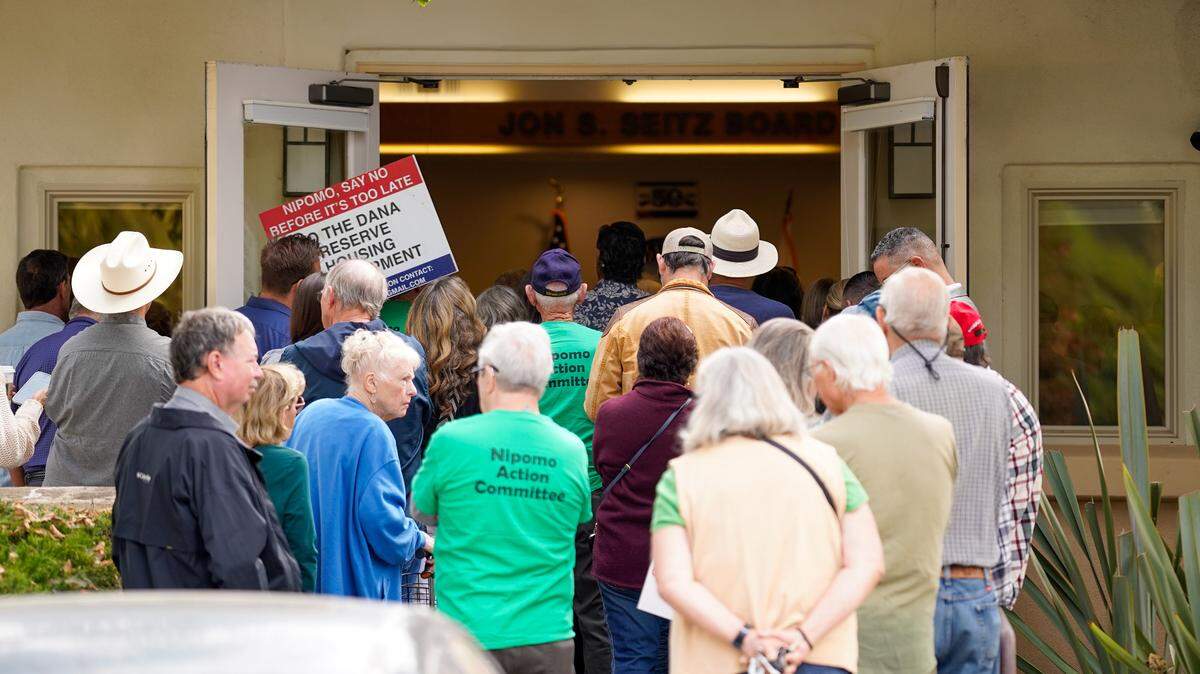 Supporters and opponents of the Dana Reserve housing development try to crowd into a Nipomo Community Services District meeting Wednesday, Aug. 28, 2024. The Nipomo CSD voted to approve the terms of an annexation agreement with San Luis Obispo County that would bring the Dana Reserve land into the CSD’s sphere of influence.