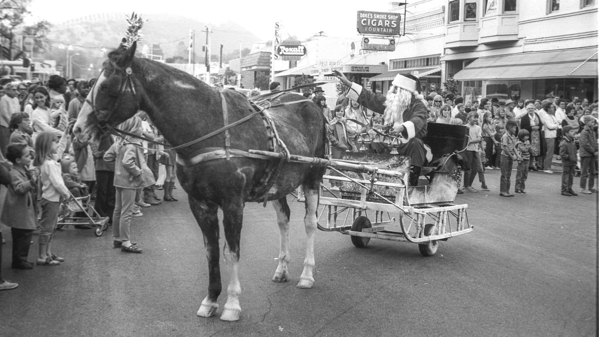 Santa Claus makes a 1963 ride in a wheeled sleigh drawn by horse in downtown Paso Robles.
