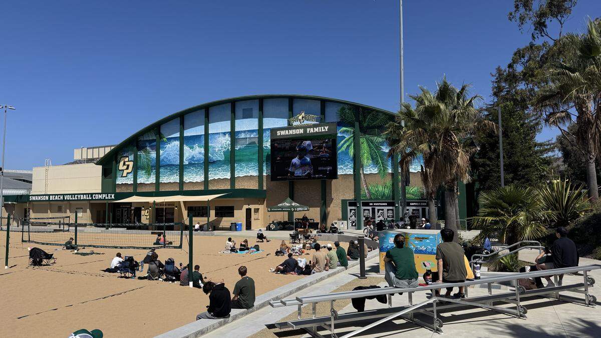 Cal Poly fans watch the baseball team’s Super Regional opener from the beach volleyball courts on campus, on Friday, June 5, 2026.