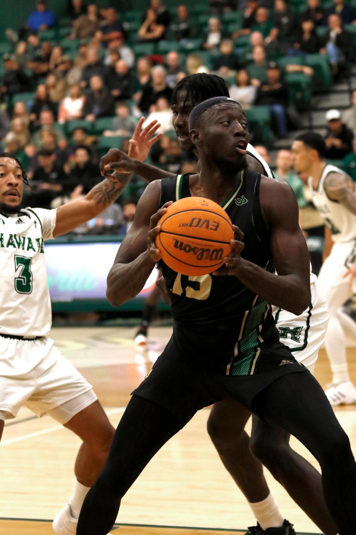Cal Poly’s Ali Koroma (15) gets pressure from Hawaii’s JoVon McClanahan (3) and Mor Seck (23). Cal Poly fell to Hawaii 69-56 in a men’s basketball game at Mott Athletic Center in San Luis Obispo on Saturday, Feb. 4, 2023.