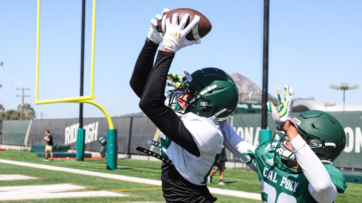Wide receiver Makhi Johnson makes a catch in front of defensive back Boston Wilson as the Cal Poly football team practices on Aug. 29, 2022, while preparing for its 2022 season opener.